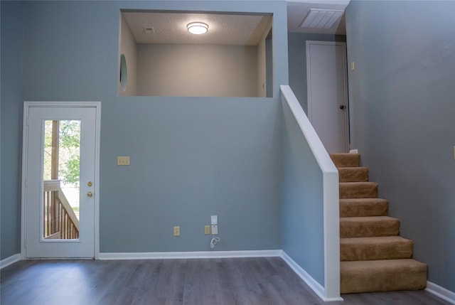 interior space with hardwood / wood-style flooring and a textured ceiling