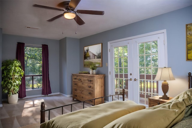 bedroom featuring ceiling fan, multiple windows, access to outside, and french doors