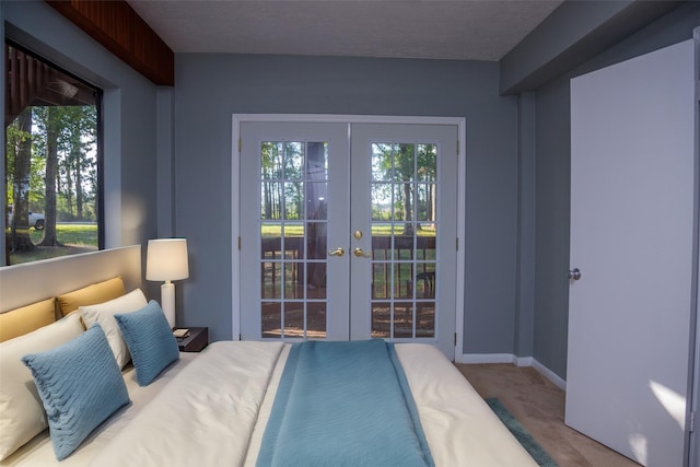 carpeted bedroom featuring access to outside and french doors