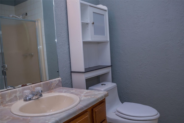 bathroom with toilet, walk in shower, and vanity