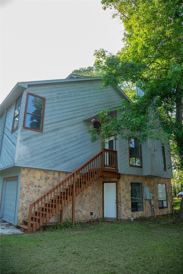 view of property exterior featuring a garage and a yard