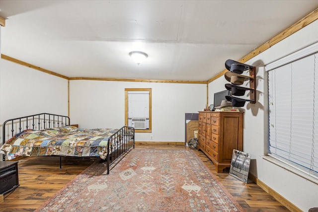 bedroom featuring hardwood / wood-style floors, crown molding, and cooling unit