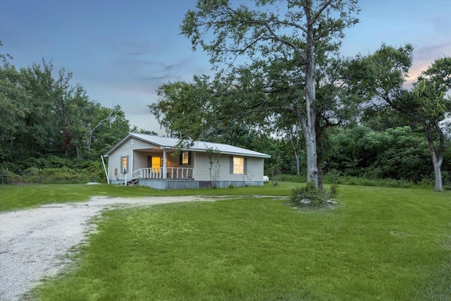 view of front of home with a lawn and a porch