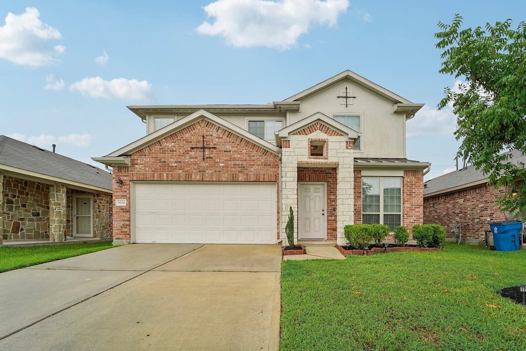 view of front of home with a garage and a front lawn