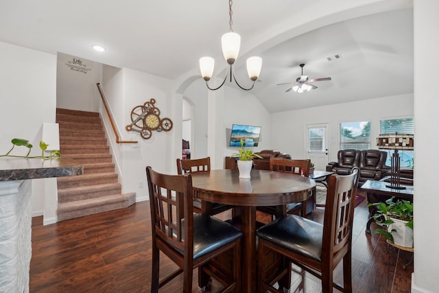 dining room featuring lofted ceiling, dark wood-type flooring, and ceiling fan with notable chandelier