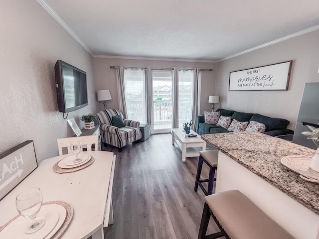 living room featuring crown molding, a textured ceiling, and hardwood / wood-style flooring