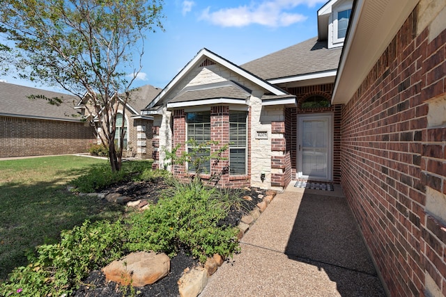 view of exterior entry featuring a yard