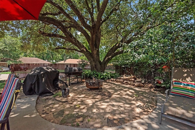 view of patio / terrace featuring an outdoor fire pit and a grill