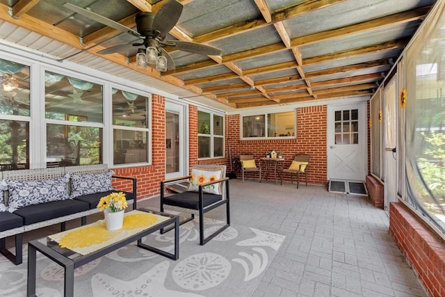 sunroom / solarium featuring ceiling fan