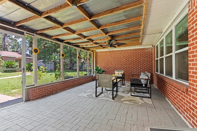 unfurnished sunroom with plenty of natural light and ceiling fan