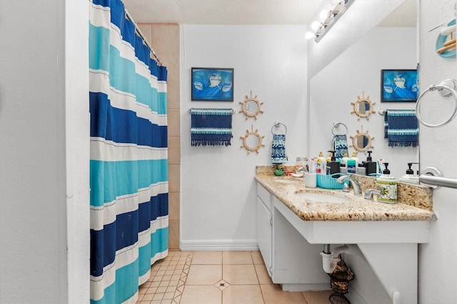 bathroom with tile patterned flooring, sink, and walk in shower