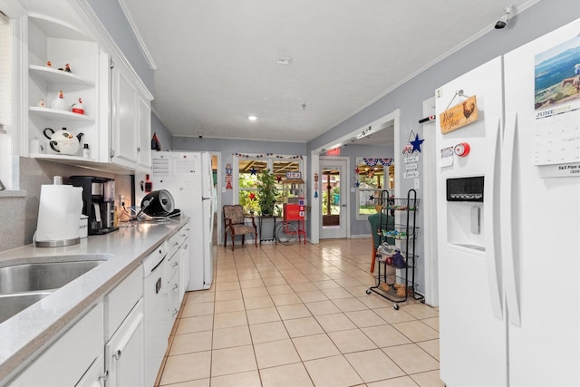 kitchen with crown molding, white appliances, white cabinets, and light tile patterned flooring