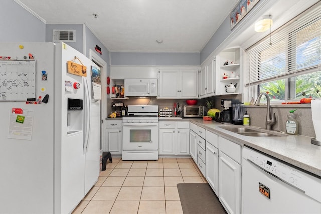 kitchen with sink, white appliances, crown molding, white cabinetry, and light tile patterned flooring