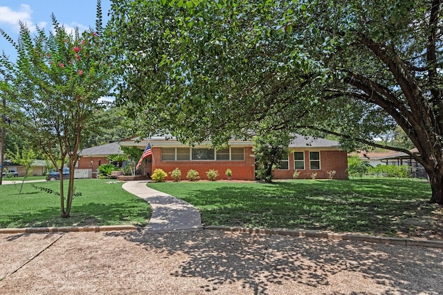 ranch-style home with a front lawn