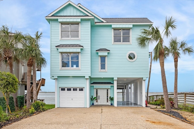 raised beach house with a carport and a garage