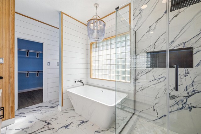 bathroom with independent shower and bath, a chandelier, and wood walls