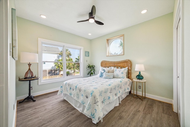 bedroom with ceiling fan and wood-type flooring