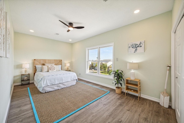 bedroom with ceiling fan and wood-type flooring