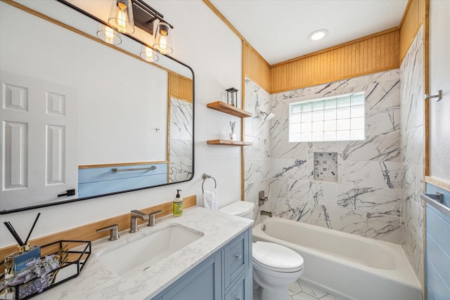 full bathroom with toilet, vanity, and tiled shower / bath