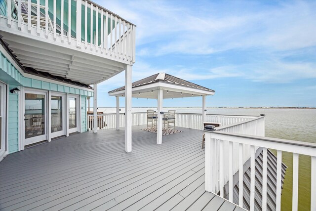 wooden deck featuring a water view