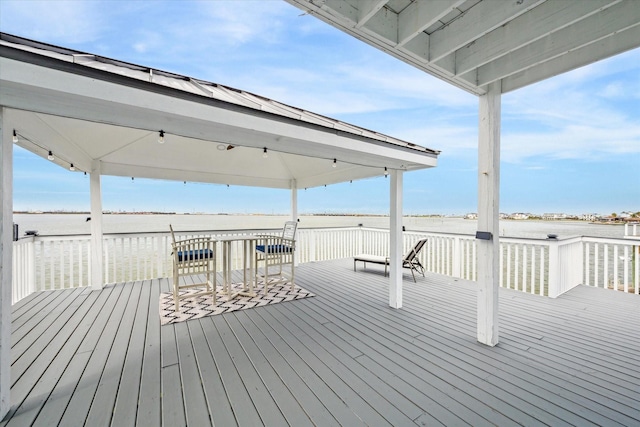 wooden deck with a water view and a gazebo