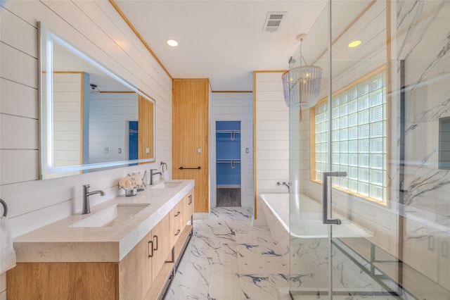 bathroom featuring ornamental molding, separate shower and tub, vanity, and a chandelier