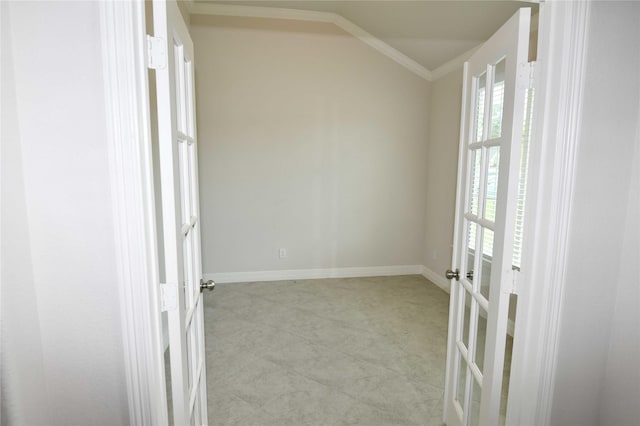 unfurnished room featuring french doors, crown molding, and vaulted ceiling