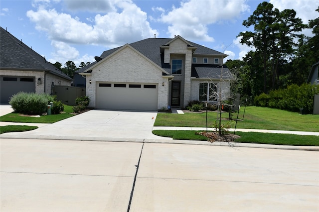 view of front facade with a garage and a front yard