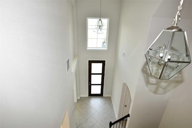 entryway featuring a towering ceiling