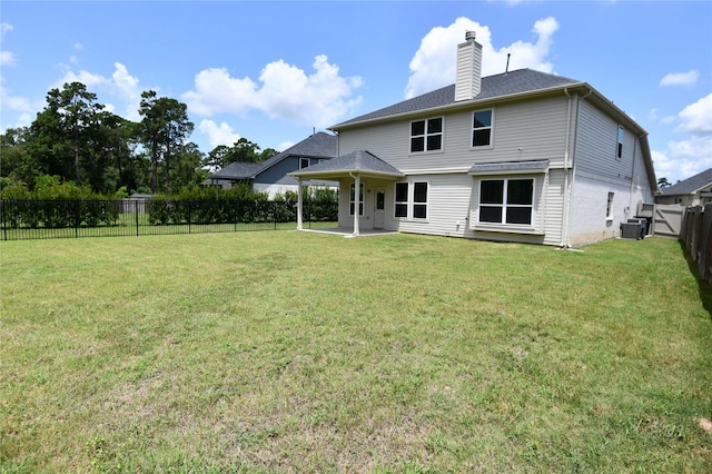 rear view of house with a patio area, central AC unit, and a lawn