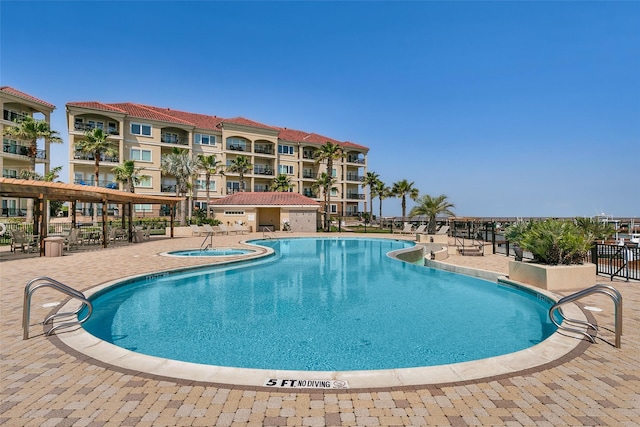 301 E Houston St Unit 3301, Port Isabel, TX 78578 - community pool with a hot tub, a patio, and fence