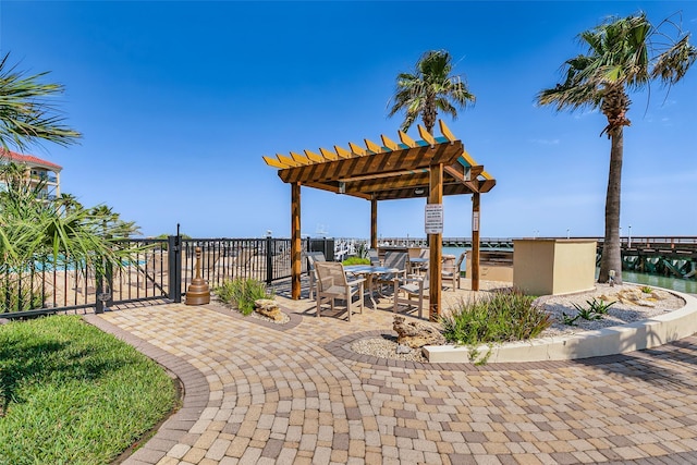 301 E Houston St Unit 3301, Port Isabel, TX 78578 - view of patio featuring a pergola, a water view, and outdoor dining space