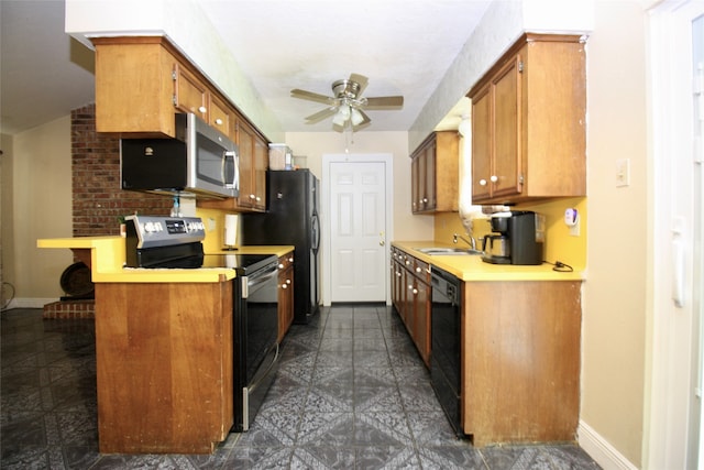 kitchen with sink, dark tile patterned flooring, ceiling fan, and stainless steel appliances