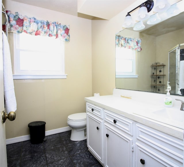 bathroom with vanity, toilet, and tile patterned floors