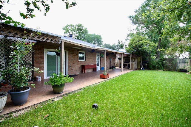 2202 Jones St, Rosenberg, TX 77471 - rear view of property with a patio area, brick siding, and a ceiling fan