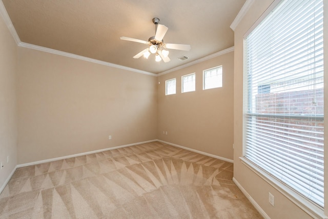 empty room with light carpet, ceiling fan, ornamental molding, and baseboards