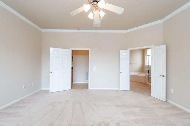 unfurnished bedroom featuring light carpet, connected bathroom, baseboards, and crown molding