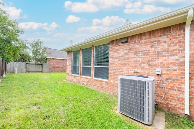 view of yard with central AC unit and a fenced backyard