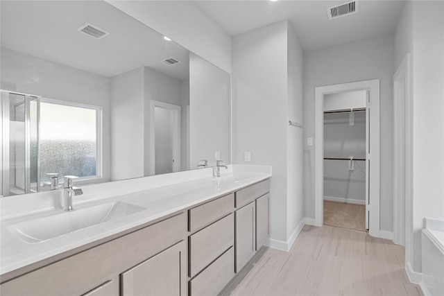 bathroom featuring vanity and an enclosed shower