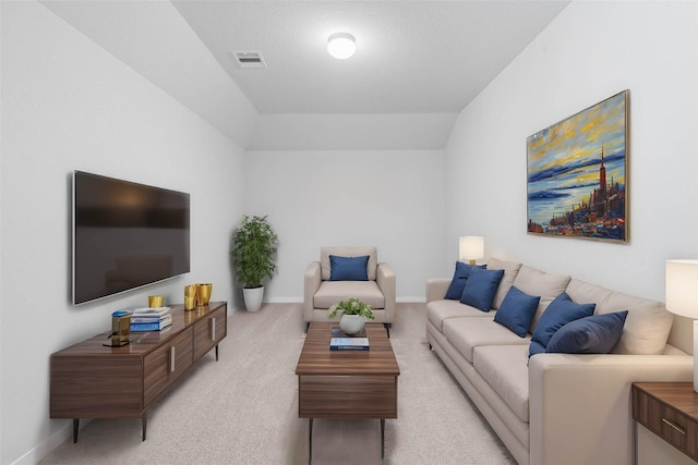 carpeted living room featuring lofted ceiling and a textured ceiling