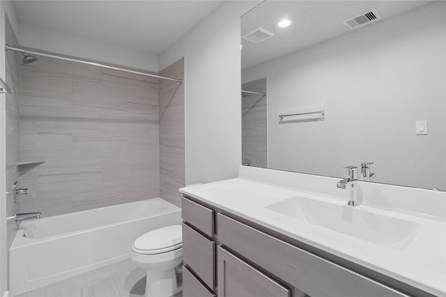 full bathroom featuring tile patterned floors, vanity, toilet, and tiled shower / bath