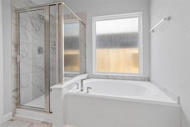 bathroom featuring shower with separate bathtub