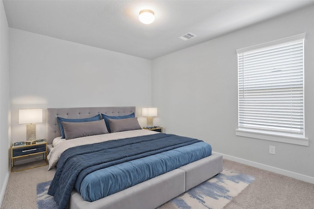 bedroom featuring light carpet