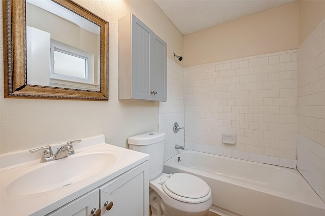 full bathroom featuring toilet, vanity, tiled shower / bath combo, and a textured ceiling