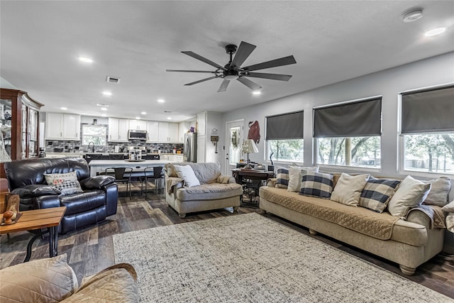 living room with ceiling fan, dark hardwood / wood-style flooring, and sink