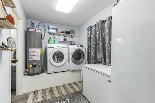 washroom with dark wood-type flooring, separate washer and dryer, and gas water heater