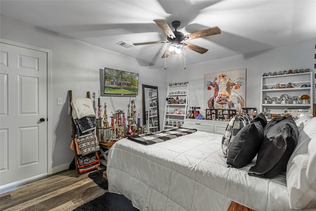 bedroom featuring ceiling fan and dark hardwood / wood-style floors