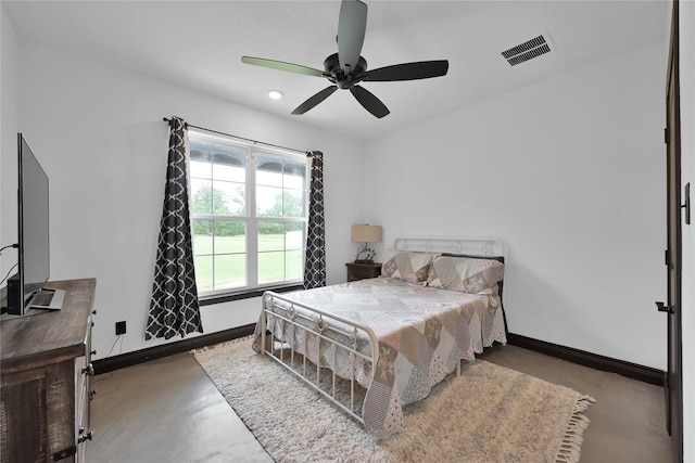 bedroom with ceiling fan and concrete floors