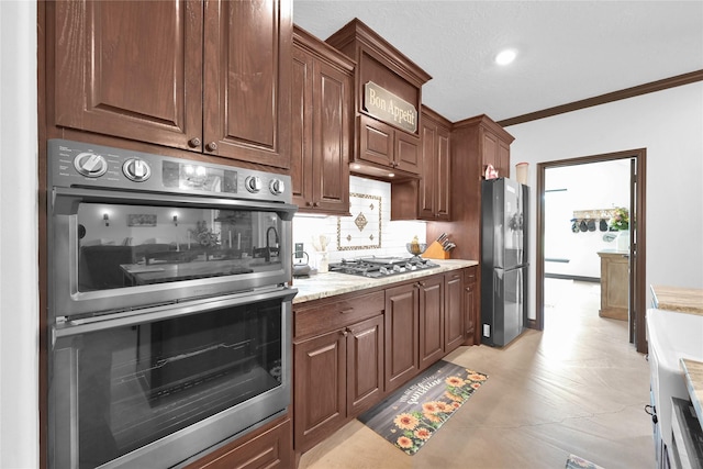 kitchen with tasteful backsplash, light stone countertops, stainless steel appliances, and ornamental molding