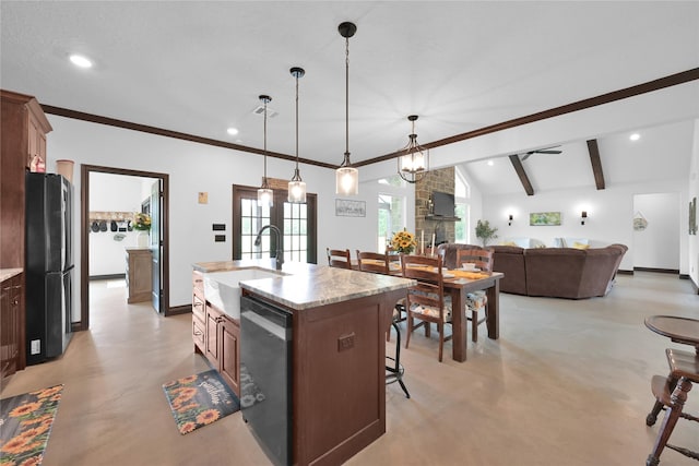 kitchen featuring decorative light fixtures, dishwasher, black fridge, a kitchen breakfast bar, and an island with sink